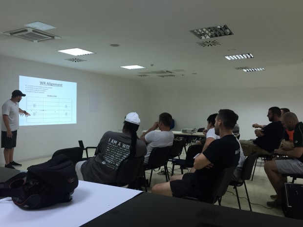 Cineplexx Blue Devils' head coach Tyler Harlow giving a presentation on the wide receiver position.